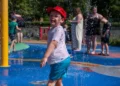 Families cool off at splash pad as schools stay closed for second day