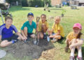 Children plant trees as symbols of school values